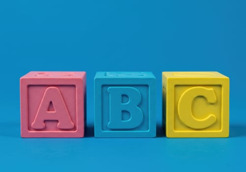Colorful abc blocks arranged on a vibrant blue background, perfect for education. photo