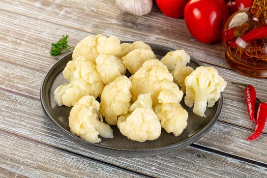 A plate of cauliflower on a wooden table photo