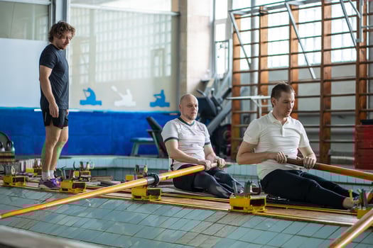 Dedicated coach observe water sports athletes, show proper posture on synchronized rowing training photo