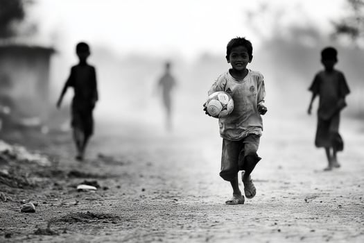 A black and white photo of children playing soccer