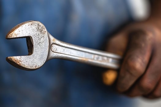 A man holding a wrench in his hand photo