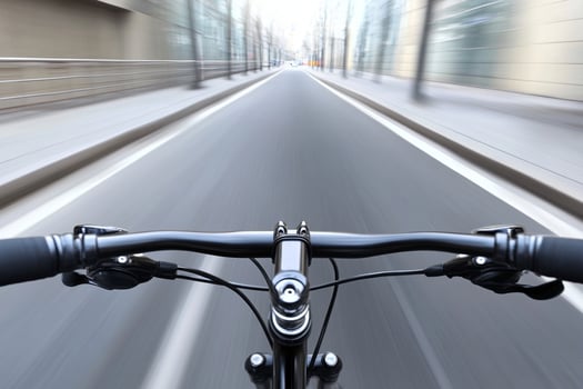 A bicycle is riding down a city street photo