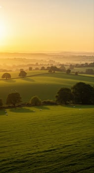 A stunning panoramic vista showcasing a tranquil landscape under a vibrant, warm sunrise. photo
