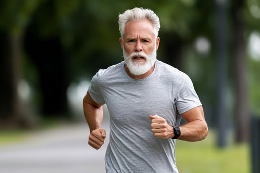 An older man with a white beard running photo