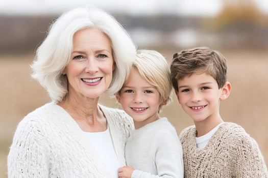 An older woman and two children in a field photo