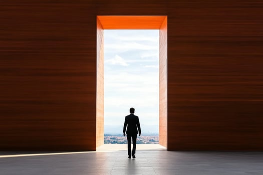 A man standing in front of a large open door photo
