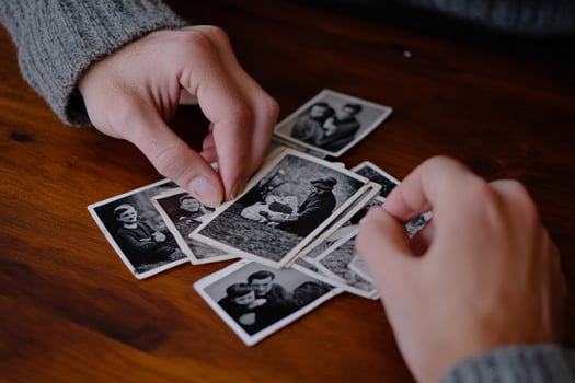 A person is holding a photo of their family
