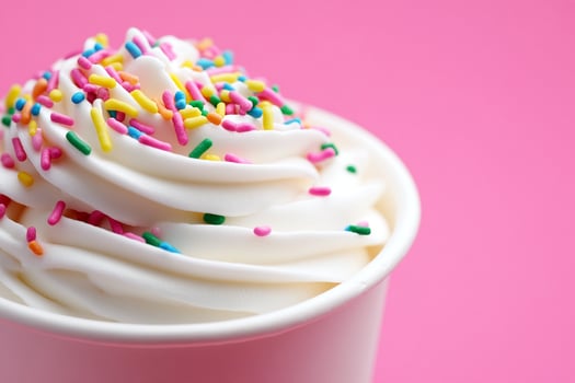 A cup of whipped cream with sprinkles on top photo