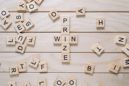 A wooden cross with the letters WIN PRIZE written in the middle photo