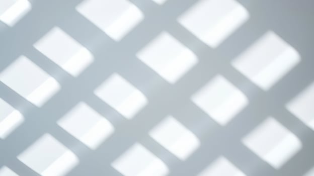 Abstract soft light grid shadow pattern with blurred square shapes creating a minimal and geometric visual effect on smooth surface. photo