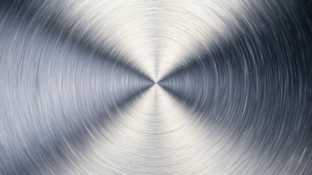 Brushed circular pattern on polished metal surface showcasing radial texture with a modern industrial appearance. photo