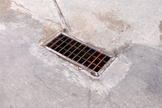 A water channel cover on a concrete road photo