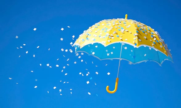 Bright Yellow Umbrella with Blue Interior Surrounded by Falling Confetti Against a Clear Blue Sky Ideal for Creative and Joyful Concepts photo