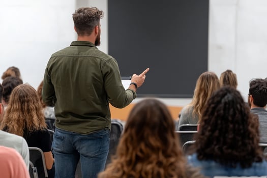 A man is giving a presentation to a group of people photo
