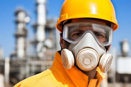 A man wearing a gas mask and yellow safety helmet photo
