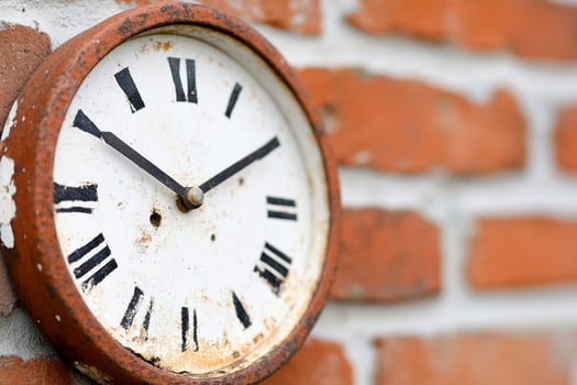 A clock on a brick wall photo