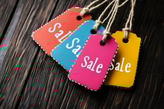 Colorful sale tags hanging on rustic wooden background.. photo