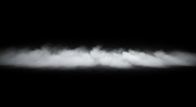 A black and white photo of smoke rising from the water
