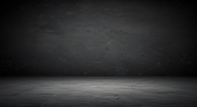 An empty room with a dark wall and concrete floor photo