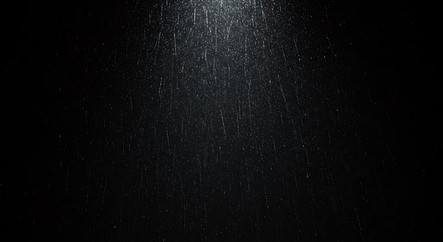 Rain falling on a black background photo