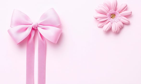 Pink Bow and Flower Arrangement on Soft Pink Background Perfect for Celebrations, Gifts, Events, and Romantic Occasions photo