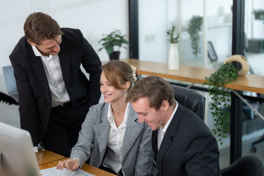 Business team collaborates to solve a project in modern office setting during daytime photo