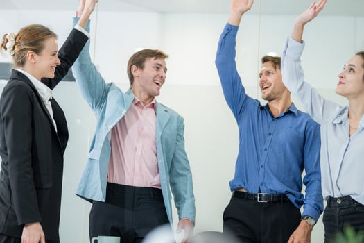 Colleagues celebrating a successful meeting in a conference room during the afternoon photo