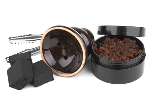 Coal with tobacco for hookah on a white photo