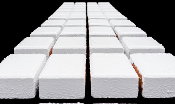 White sugar cubes arranged in a perfect geometric pattern on a black background showcasing detail, texture, and composition for culinary and food visuals photo