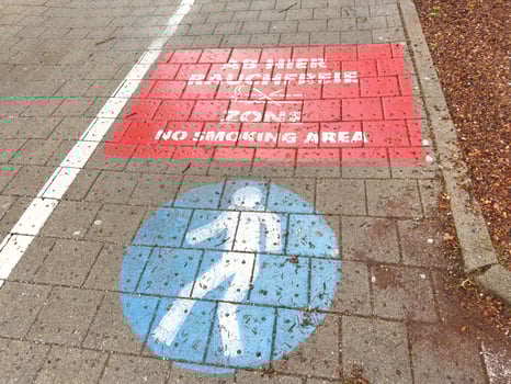 No smoking area and pedestrian zone markings on pavement photo