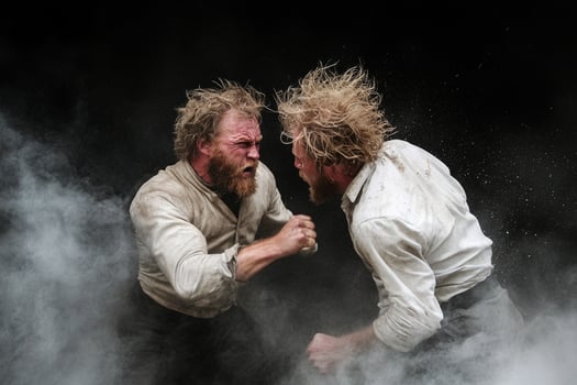 Two men fighting in the dust with smoke photo