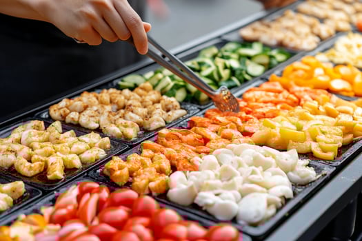 A person is holding a tray of vegetables photo