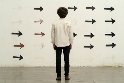 A man standing in front of a wall with arrows pointing in different directions photo