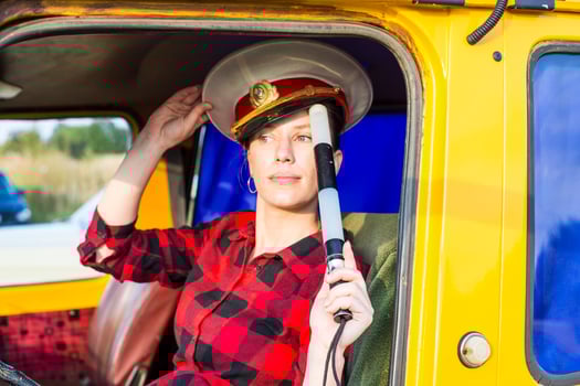 Moscow, Russia, 09.10.2017. A woman in a red and black plaid shirt is sitting in a yellow truck photo