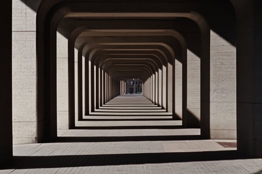 A long tunnel with a light shining through it photo