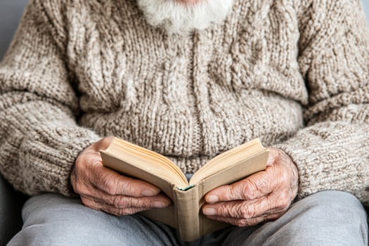 An old man with a white beard and a book photo