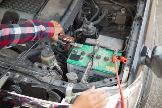 A man is holding a battery in his hand photo
