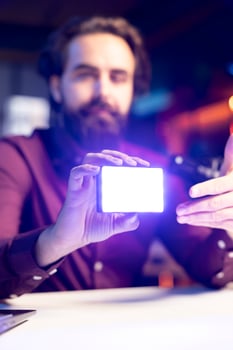 Close up shot of mini led lights, reviewed by tech guru filming technology videos. Focus on filming equipment shown by online star in blurry background to subscribers, talking in mic photo