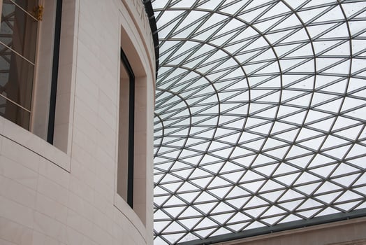 The Great Court's glass and steel roof at the British Museum in London features a geometric lattice design with natural light illuminating the space. photo