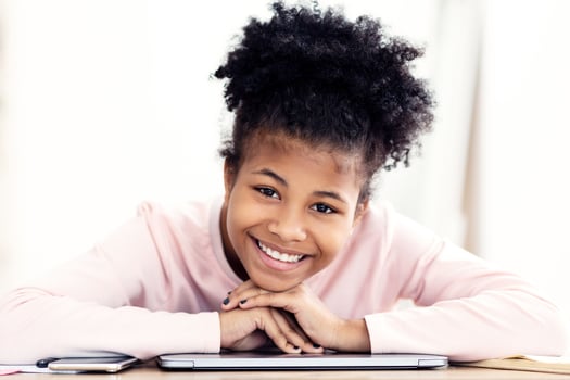 Cheerful Black Teen Girl Smiling To Camera Sitting At Desk At Home. Teenager's Portrait photo