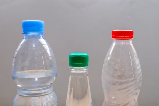Plastic beverage bottles with different shapes and cap colors photo