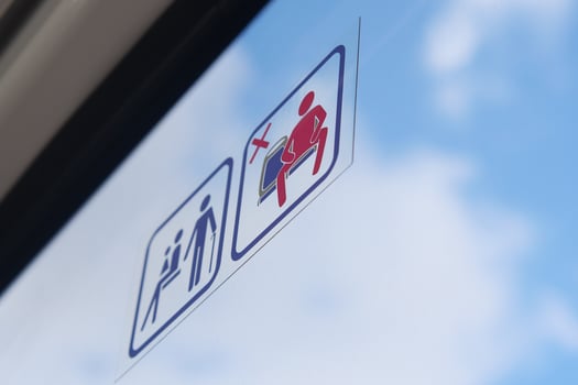No standing signs on a public transport vehicle during daytime hours photo