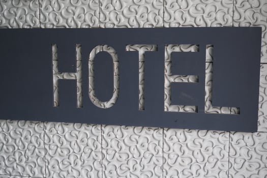 Modern hotel signage displayed on textured wall surface photo