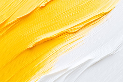 A close up of a yellow and white paint brush photo
