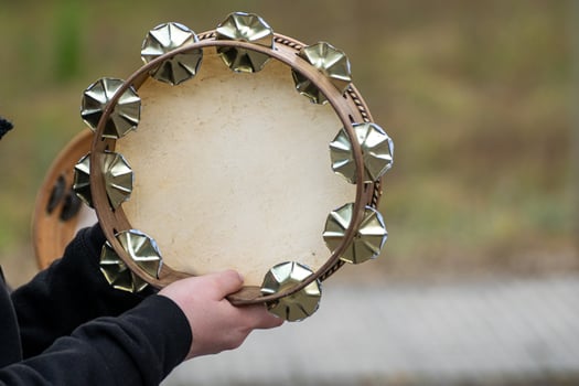 Close up of woman hands playing tambourine at a popular festival in Galicia. Folk music concept, traditional photo