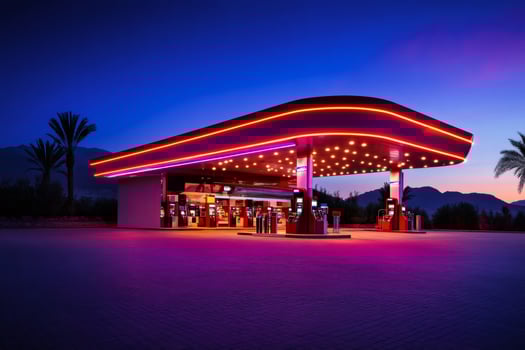 Futuristic gas station with neon lights shining at dusk photo