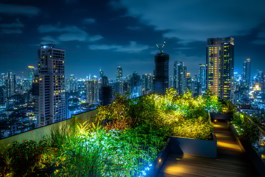 Rooftop garden offering stunning view of illuminated cityscape at night photo
