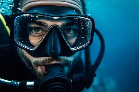 Diver wearing scuba mask and regulator, exploring the deep blue sea photo