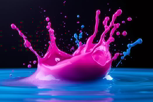 Pink and blue paint splashing in water creating crown shape photo