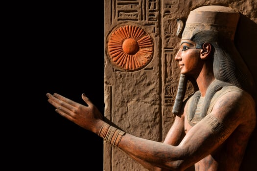Ancient egyptian pharaoh statue extending hand in welcome photo